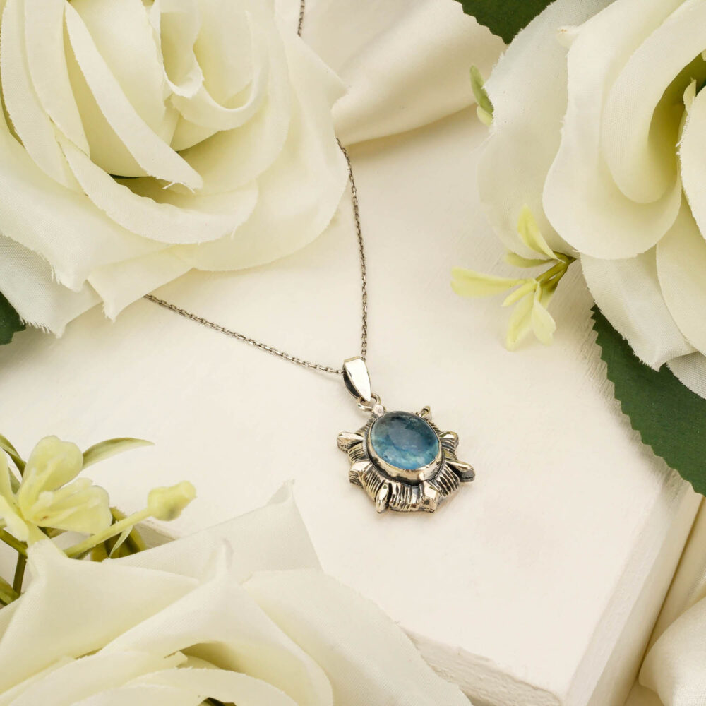 Handcrafted unisex pendant necklace featuring a genuine aquamarine gemstone in 925 sterling silver on white