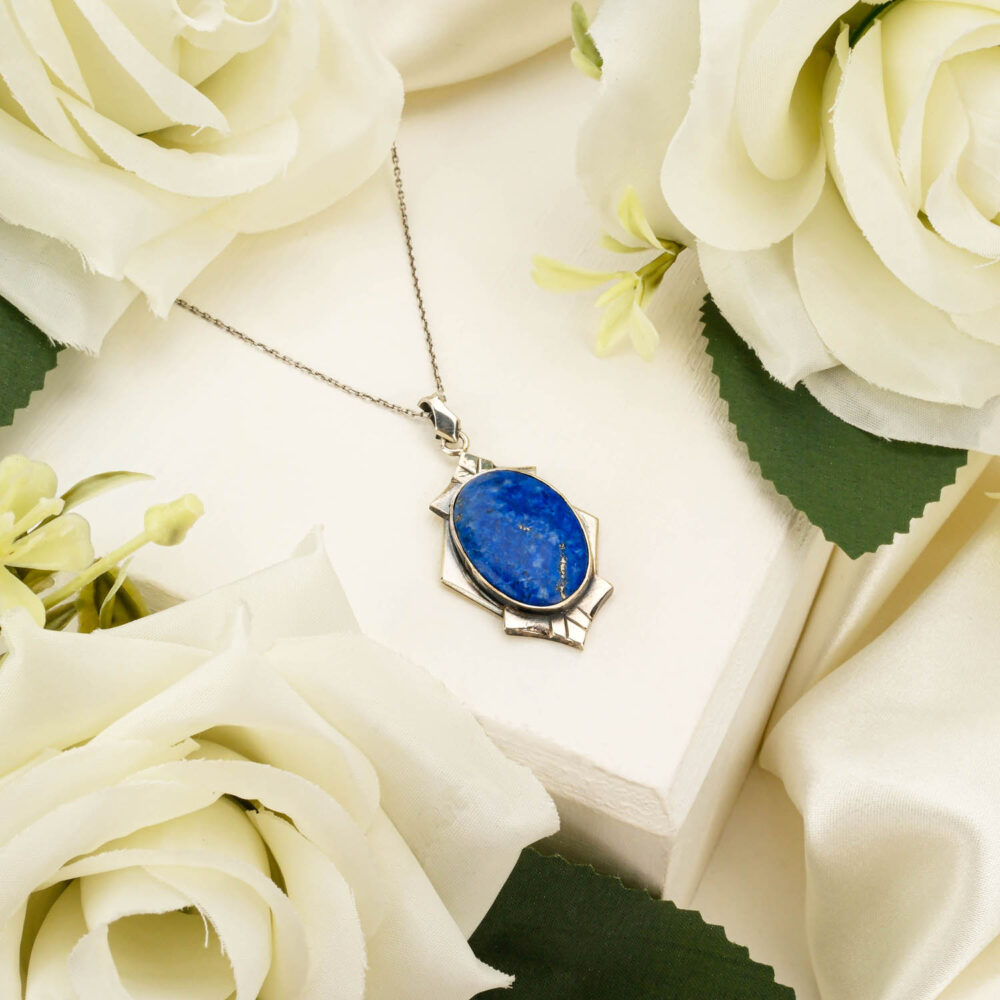 Handcrafted unisex pendant necklace featuring a genuine oval Lapis Lazuli gemstone in 925 sterling silver on white