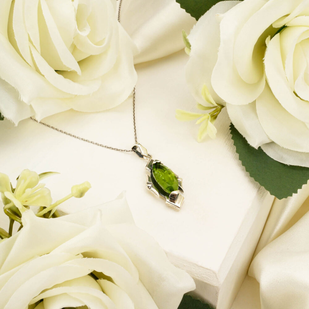 Handcrafted unisex pendant necklace featuring a marquise-cut peridot gemstone in 925 sterling silver on white