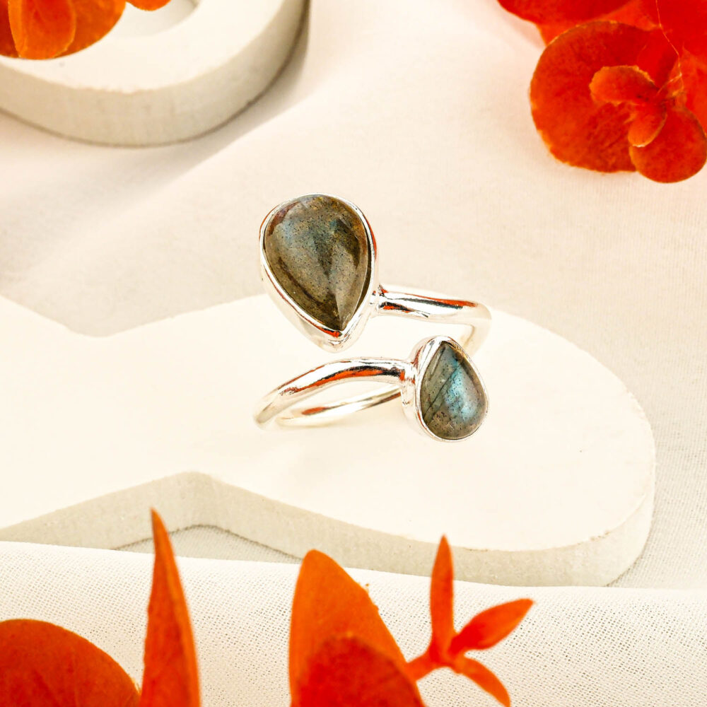 Artisan 925 sterling silver ring featuring teardrop labradorite stones with blue flash in a modern bypass design