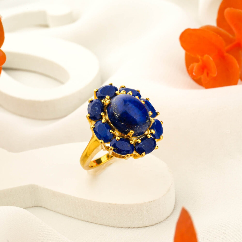 Gold-plated 925 sterling silver ring featuring a large oval lapis lazuli cabochon surrounded by a blue stone halo