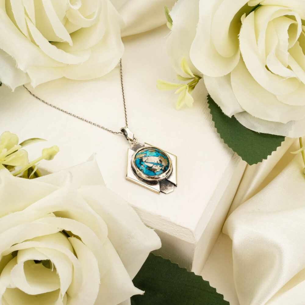 Handcrafted unisex pendant necklace featuring a genuine Persian turquoise gemstone in 925 sterling silver on white