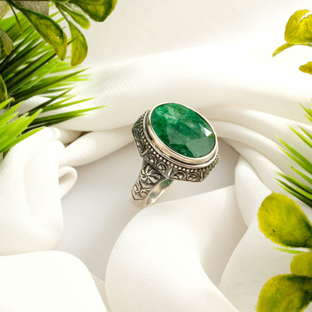 Handcrafted Zambian emerald men's ring in 925 sterling silver on display