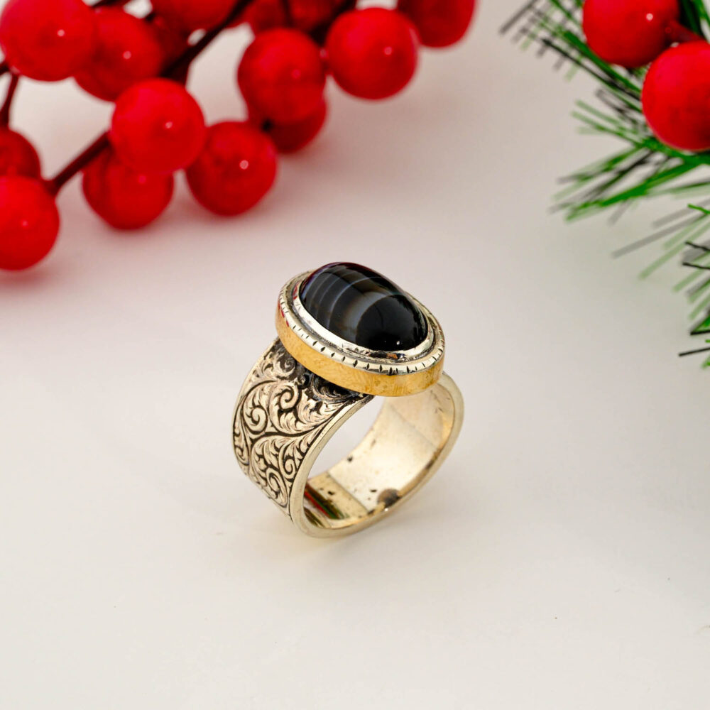 925 sterling silver men's ring featuring a natural banded black agate in a gold-tone bezel with intricate floral engravings on the band