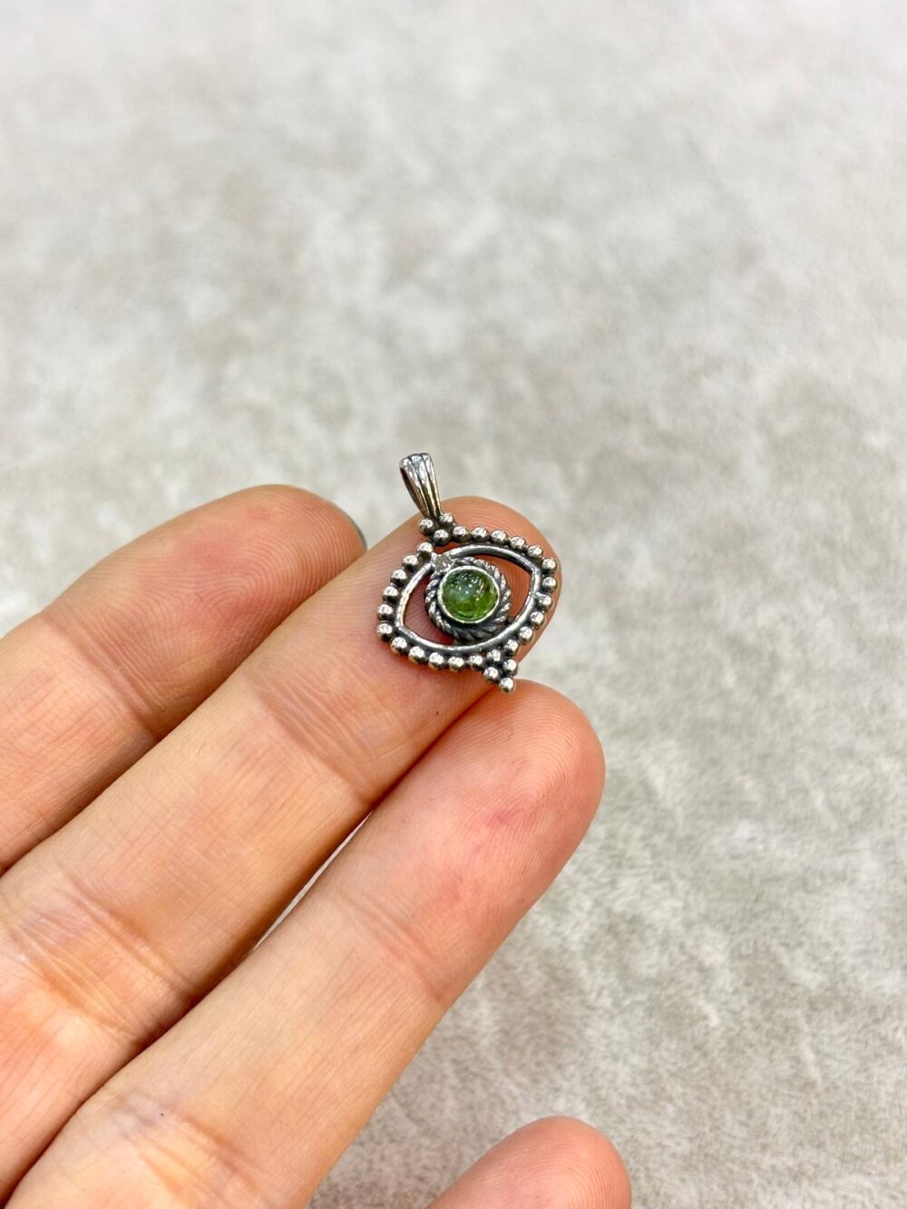 Oxidized sterling silver eye shaped pendant with natural round green tourmaline stone and beaded detail
