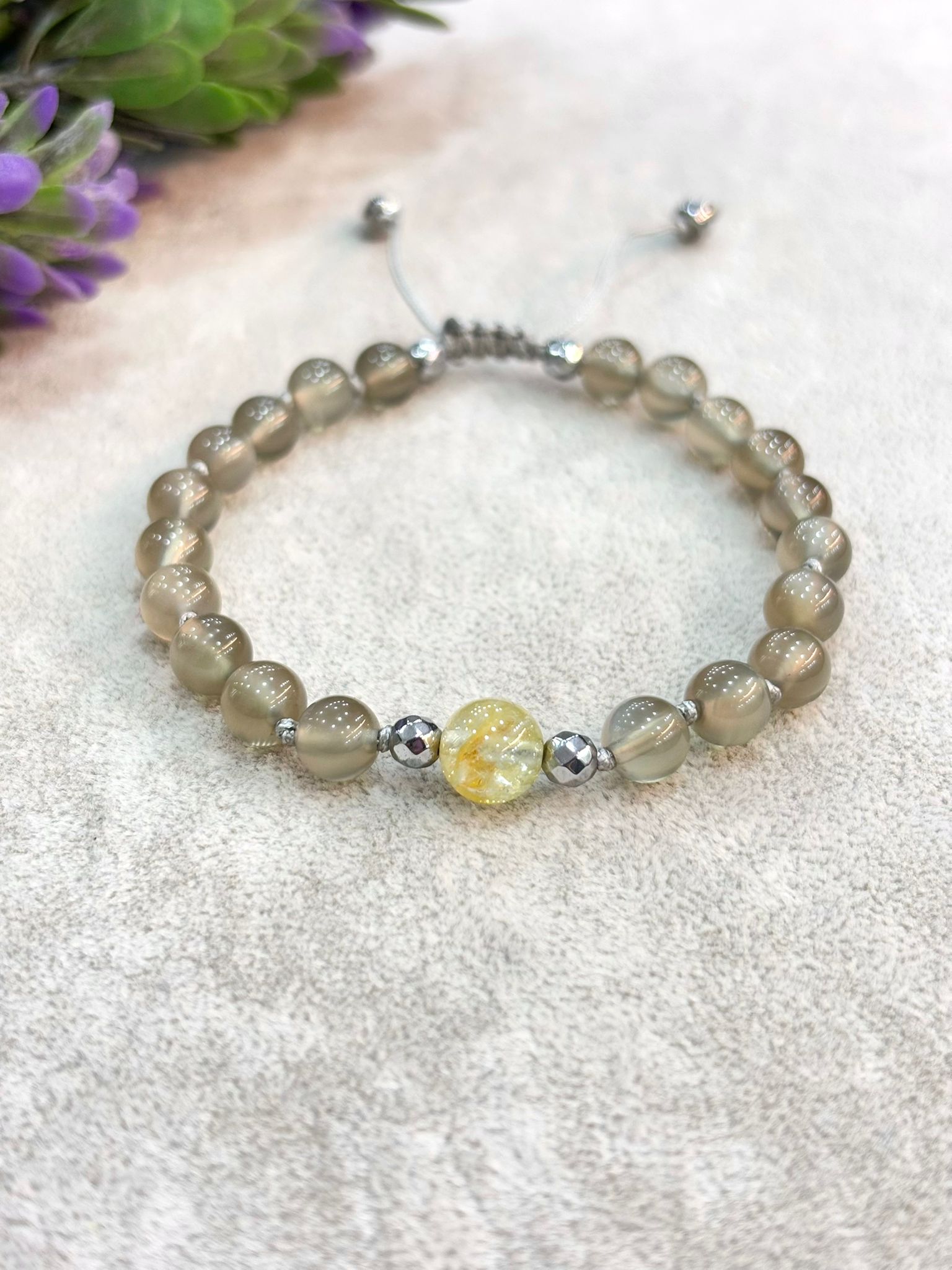 Natural translucent grey moonstone beaded bracelet with single yellow topaz bead and adjustable grey cord