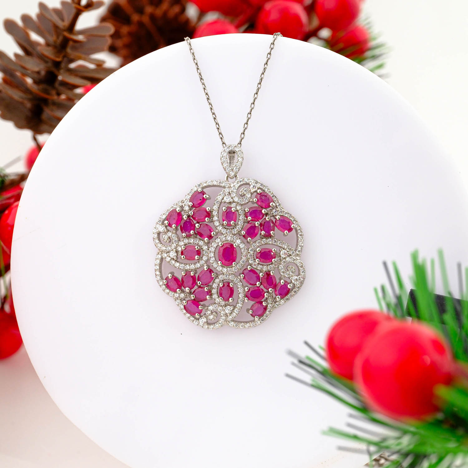 925 sterling silver necklace featuring an intricate floral mandala pendant set with multiple natural red rubies and pave crystals