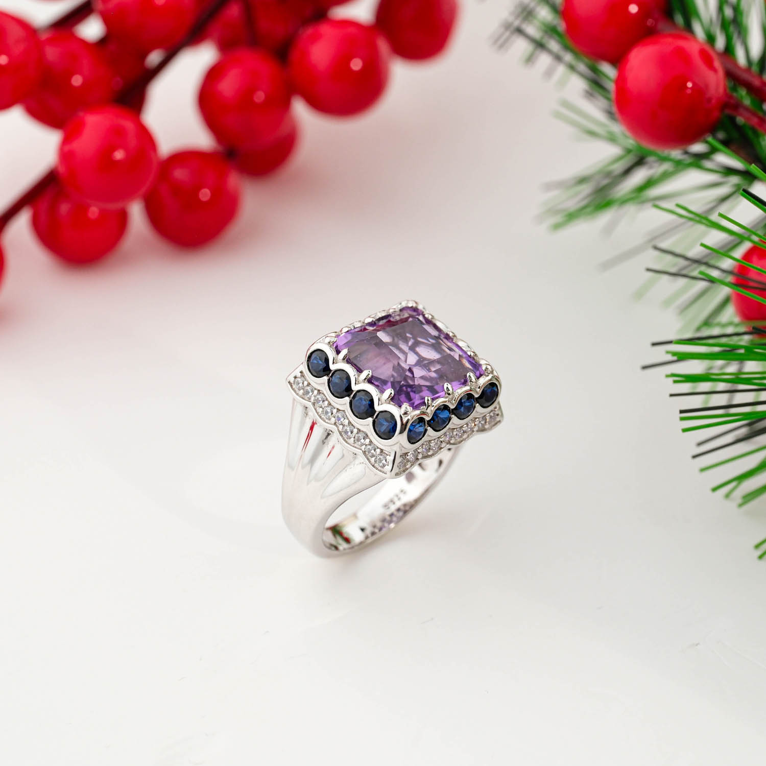 Chunky 925 sterling silver unisex ring featuring a large square cut amethyst surrounded by a dark blue stone halo and pave crystals