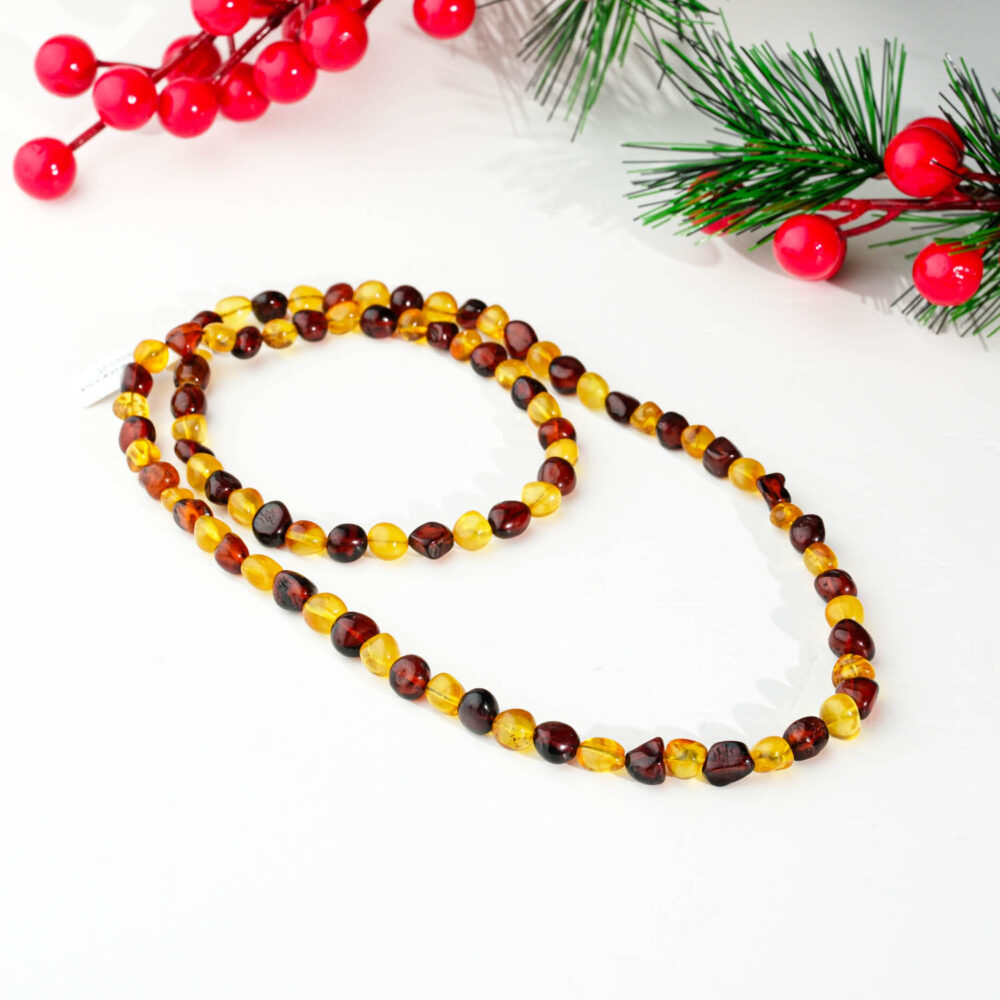 Original certified natural multi-color amber adult necklace featuring polished baroque beads in cherry and honey tones on a white background